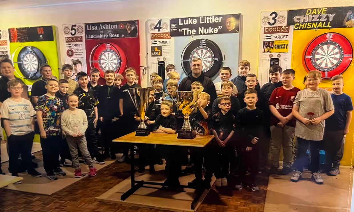 Luke Littler with fellow members of the St Helens Darts Academy after winning a tournament at the age of 14 with an average of 111.33.